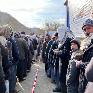 People queueing for assistance in two lines. 